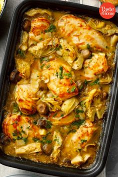 chicken and artichoke casserole in a baking dish with bread on the side