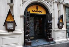 the entrance to a building with two clocks on it