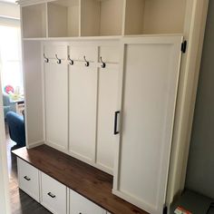 a room with some white cabinets and drawers