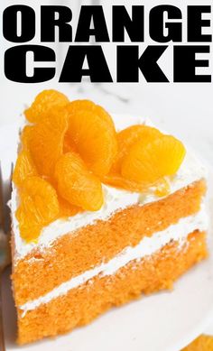 an orange cake with white frosting and sliced oranges on top, sitting on a plate