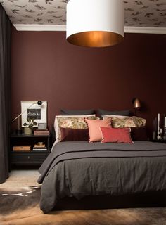 a bedroom with a bed, nightstands and lamps on the side tables in front of it