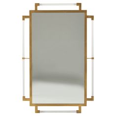 a white and gold framed mirror sitting on top of a table