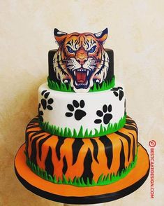 a three tiered cake decorated with an image of a tiger