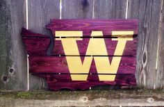 a wooden sign with the letter w painted on it