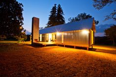 a small cabin is lit up at night