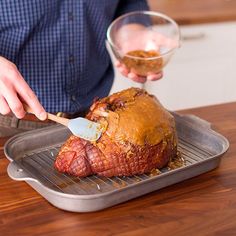 a man is spreading icing on top of a meat