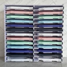 several different colored file folders stacked on top of each other in a storage rack