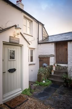 a white building with a door and steps leading up to it