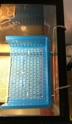 a blue basket sitting on top of a shelf