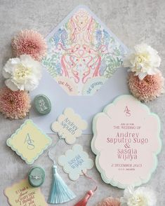 the wedding stationery is laid out with flowers and other things to put on it