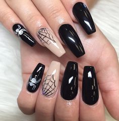 black and white nails with spider web designs on them