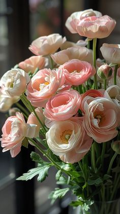 a vase filled with pink and white flowers