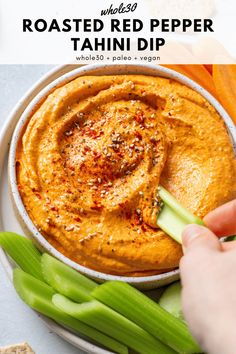 a bowl filled with roasted red pepper tahini dip