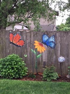 a fence with butterflies painted on it and the words linda's post above them