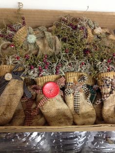 an open box filled with burlocked stockings and other christmas decorations on top of plastic plates