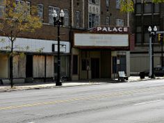 an empty street in front of a building with a sign that says palace on it