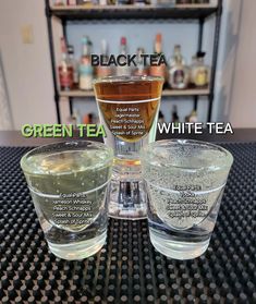 three glasses filled with different types of green tea and white tea on a counter top