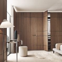 a modern bedroom with wood paneling and white furnishing on the carpeted floor