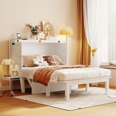 a white bed sitting next to a window in a bedroom on top of a hard wood floor