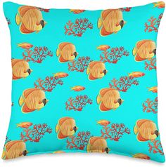 a blue pillow with an orange fish and corals pattern on it's side