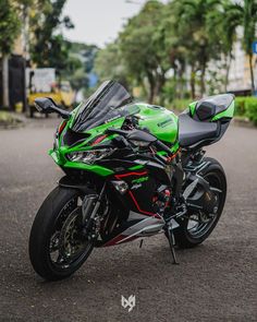 a green and black motorcycle parked on the street