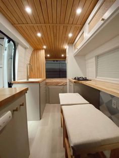 an interior view of a camper with wood paneling