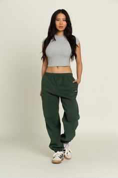 Elevate your athleisure style and feel like you're lounging on the go with our Hunter Green GH Jogger Sweatpants. The elastic waistband and tapered leg style allows you to feel secure and trendy. Complete with dual side pockets to keep your essentials close by. Pair with ur Hunter Green GH Cropped Hoodie to complete the set. Green Nike Sweatpants Outfit, Athleisure Sweatpants With Elastic Waistband For Streetwear, Green Tapered Leg Sweatpants With Elastic Waistband, Green Tapered Leg Joggers With Elastic Waistband, Athleisure Sweats With Elastic Waistband For Streetwear, Athleisure Streetwear Joggers With Elastic Waistband, Sporty Green Pants With Elastic Side Panels, Athleisure Joggers With Elastic Waistband For Streetwear, Sporty Sweats For Streetwear With Elastic Waistband