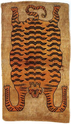 an old rug with a tiger on it's face and two hands in the shape of a rectangle