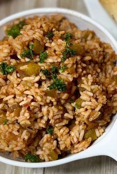 a white bowl filled with rice and vegetables