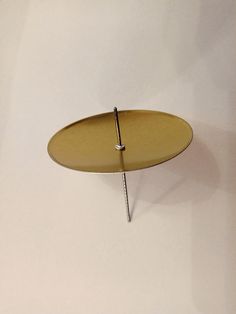 a round metal object hanging from the ceiling with nails sticking out of it's sides