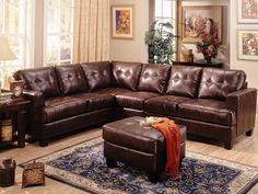 a living room with brown leather furniture and rugs