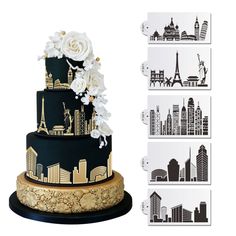 a black and gold wedding cake with white flowers on the top is surrounded by city skylines