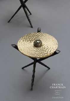 three metal stools sitting on top of each other