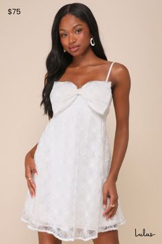 It's impossible to ignore the cute vibes you'll be bringing in the Lulus Charming Intent White Mesh Floral Applique Bow Mini Dress! This adorable dress features a mesh overlay (with floral applique details throughout) falling from adjustable spaghetti straps to shape a bodice with a sweetheart neckline and a decorative bow detail at the front. High, empire-style waist tops a flaring skirt that ends at a mini hem. Hidden zipper/clasp at back. Fit: This garment fits true to size. Length: Mid-thigh Sheer Mini Dress For Summer Garden Party, Feminine Sheer Mini Dress For Summer, White Vacation Dress With Bow Detail, White Vacation Dress With Bow, Summer Mini Dress With Bow For Garden Party, Sheer Mini Dress For Summer Brunch, Feminine Beach Dresses With Bow, Cute Summer Mini Dress With Bow, Lace Dress With Bow For Spring