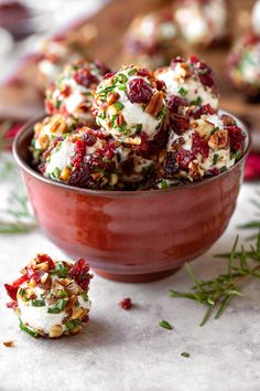 a bowl filled with white chocolate covered in cranberry and pistachio toppings