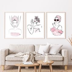 three art prints hanging on the wall above a couch