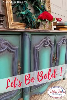 an old dresser painted in teal with the words let's be bold