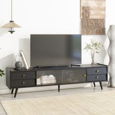 a flat screen tv sitting on top of a wooden entertainment center