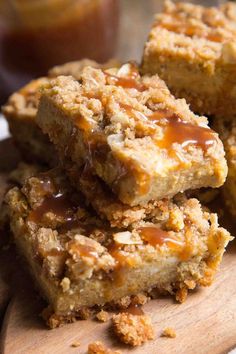 several pieces of cake sitting on top of a wooden cutting board next to a jar of peanut butter