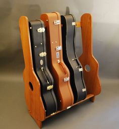 three guitar cases are stacked on top of each other in the shape of an instrument case