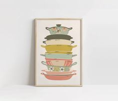 a stack of colorful pots on top of each other in front of a white wall