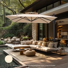 an outdoor living area with couches, tables and umbrellas on the decking