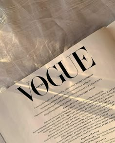 an open book with the word voque written on it