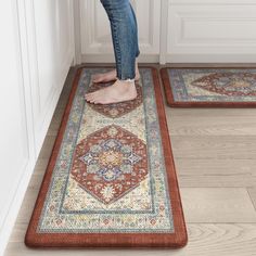 a pair of feet standing on an area rug