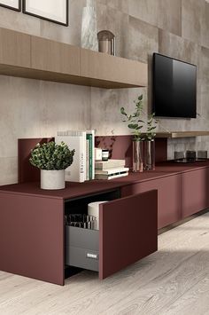 a living room with a large tv mounted on the wall next to a book shelf