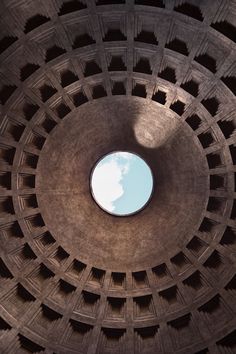 the inside of a building with a skylight in it's center and small round window