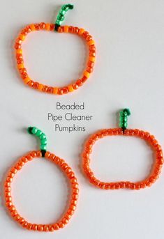 beaded pipe cleaner pumpkins made from orange beads and green caps with the words beaded pipe cleaner pumpkins on them