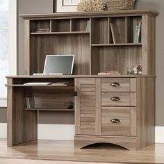 a wooden desk with drawers and a laptop on it