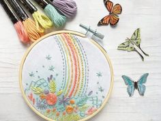 the embroidery kit is next to some butterflies