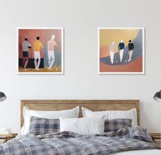 two paintings hang on the wall above a bed in a bedroom with plaid sheets and pillows